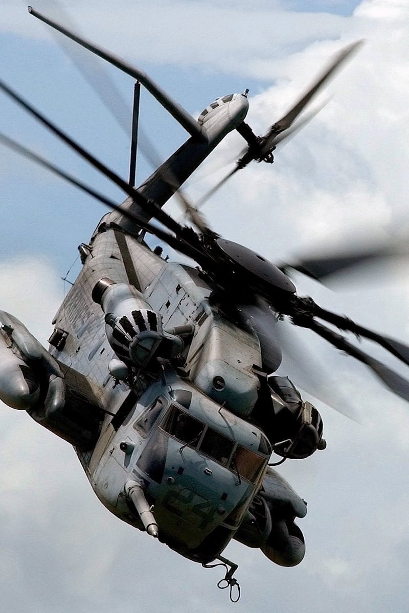 Military helicopter flying through the sky showcasing aviation power and versatility.